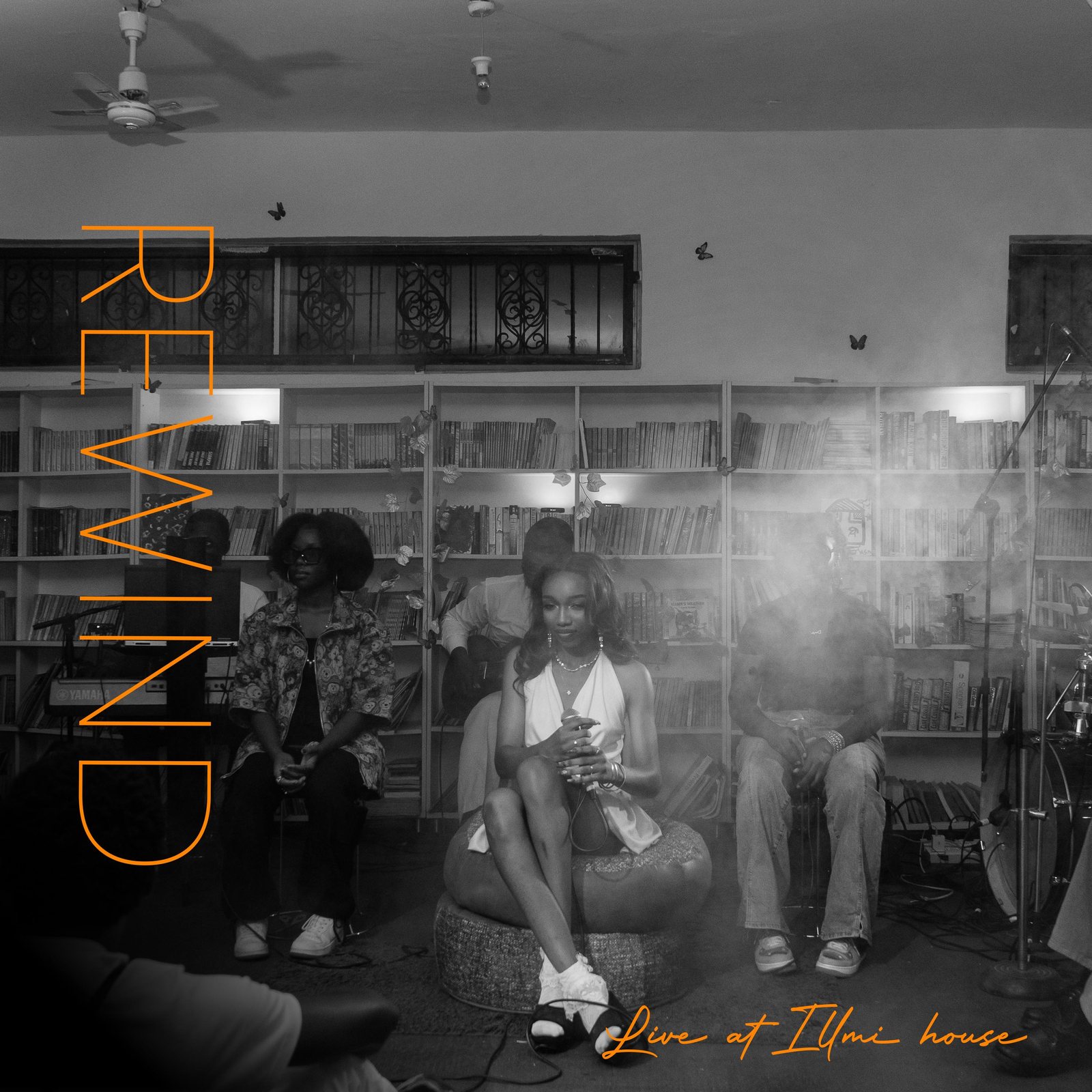 Rewind (Live at Ilmi House) cover: black-and-white photo of Fewa performing seated among an audience